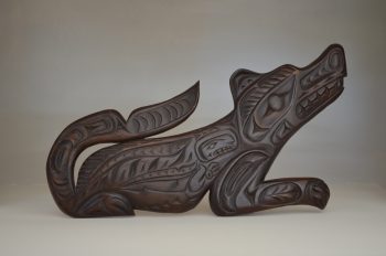 Wooden Wolf sculpture by artist Nelson Joseph, inspired by Indian petroglyphs of Sproat Lake
