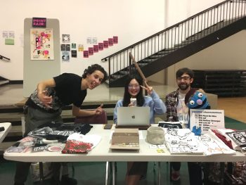 GD BFA2 Students Alejandro Cerutti, Oona Lei, and Bryan Gelderbloom run the print fair and sell their wares
