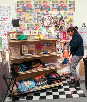 Conny Cavazos works to find the perfect place to hang her piñata submission.
