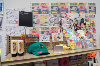 The top shelf including faux lube, caps, and postcards.
