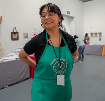 Conny shows off one of the custom screenprinted aprons for store clerks.
