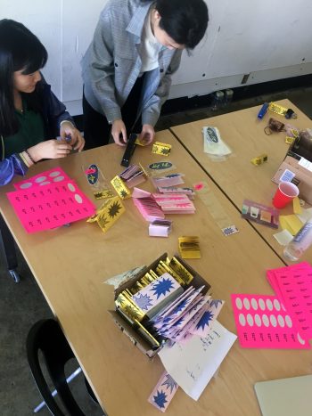 Yingyi Zhu and Taimin Ahn help to bag items in store-branded packaging.
